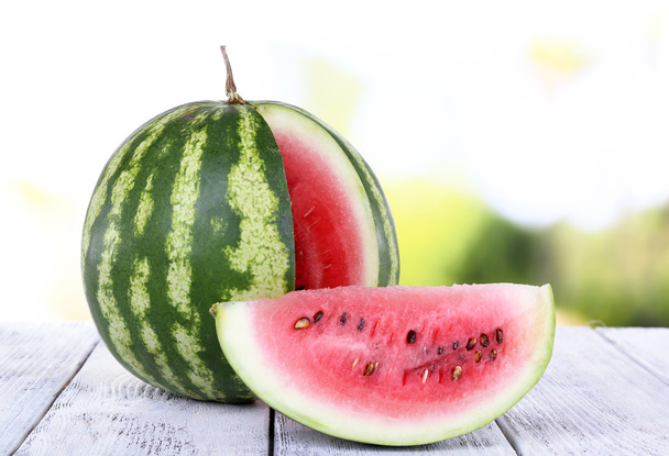 Watermelon on wooden table on natural background - Foto, immagini