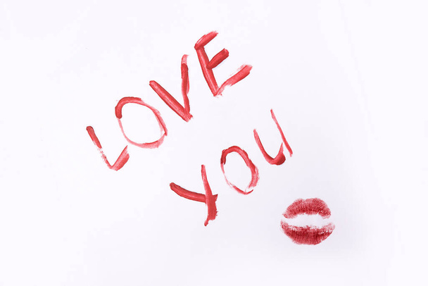 Red color lipstick paint text i love you isolated on white background - Фото, изображение