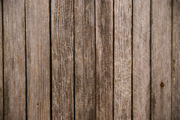 Brown or gray wood texture. Abstract background, blank template. rustic background of old wooden boards with holes and nails. Vertical arrangement of boards. - Photo, image