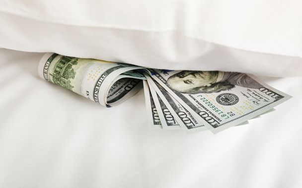 Hidden money under pillow close up - Foto, Bild