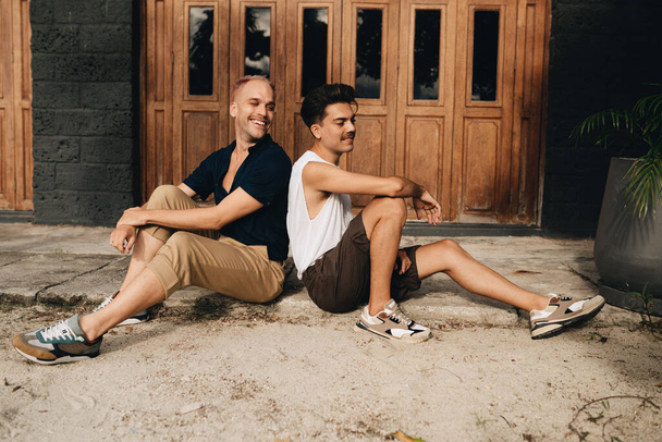 Gay Couple spend time together outdoors. Homosexual couple having fun together - Фото, изображение