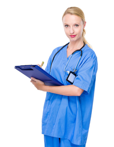Female doctor write on clipboard - Foto, imagen