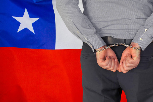 Male with handcuffs on the background of the Chile flag. Back view. Concept of prisons and corruption in Chile - Foto, Imagem