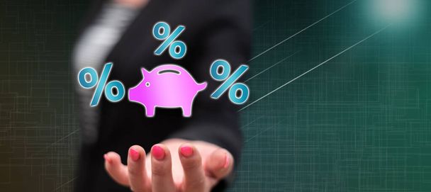 Interest rates concept above the hand of a woman in background - Photo, Image