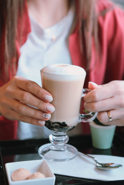 Iced coffee with milk. Iced coffee latte . Woman holding glass cup of iced coffee. - Φωτογραφία, εικόνα