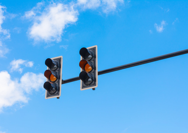 image of traffic light, the amber light is lit. symbolic  for wa - Foto, Imagen