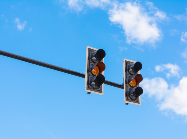 image of traffic light, the amber light is lit. symbolic  for wa - Photo, Image