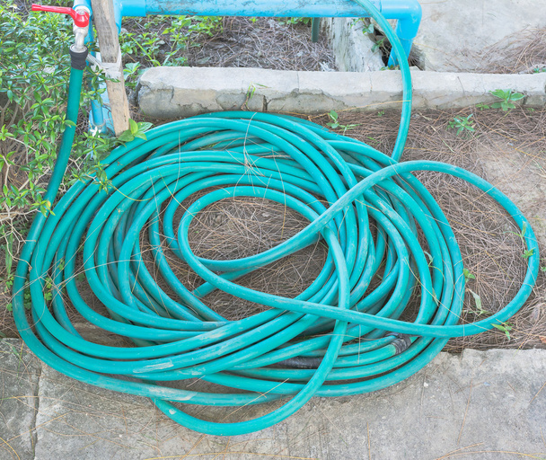 image of roll of water hose on the ground - Photo, Image