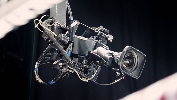 TV Camera broadcast on the crane tripod for shooting or recording and broadcasting content in studio production to on air tv or online internet live show. HD Video recording on crane. Selective focus. - Фото, изображение