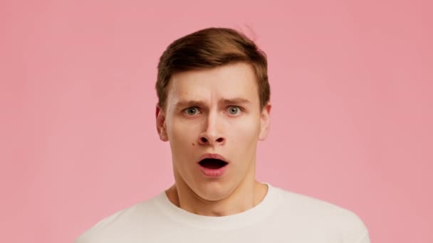 Shocked Man Looking At Camera Shaking Head Over Pink Background - Video