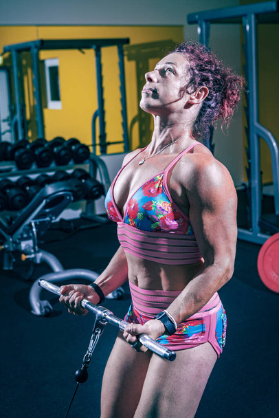 young woman working out in the gym or fitness room - Photo, image