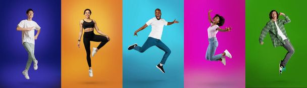 Having fun. Full length of happy multinational millennials jumping up in air on bright neon studio backgrounds - Photo, Image