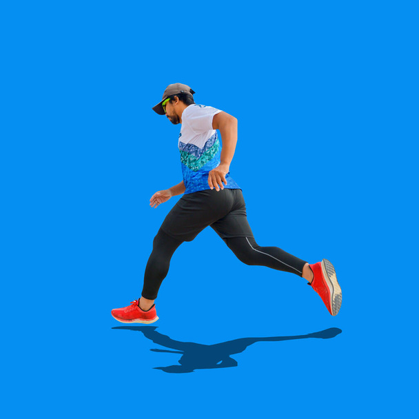 Asian man in red shoes practicing running on colored background. withclipping path - 写真・画像