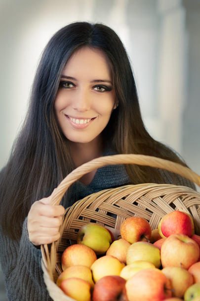 Young woman with a basket of ripe apples - Photo, Image