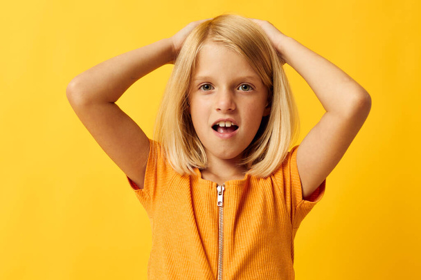 little blonde girl holding her head emotions surprise - Foto, Imagem