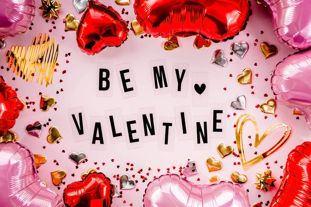Stylish text frame with the inscription be my valentine. Pink, red and gold hearts all around. Foil balloons top view of Valentine's Day. Copyspace. - Φωτογραφία, εικόνα