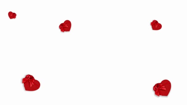 valentines day motion graphics animation gift card, red heart shape boxes with red shiny ribbon bow, isolated on white background, banner copy space, top view for mothers day or greetings card - Кадры, видео