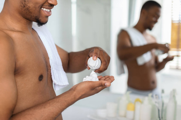 Black Man Applying Shave Foam On Arm In Bathroom, Preparing For Shaving - Фото, изображение