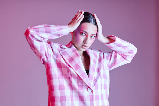 Young beautiful woman style clothing fashion posing modern style pink background unaltered - Φωτογραφία, εικόνα