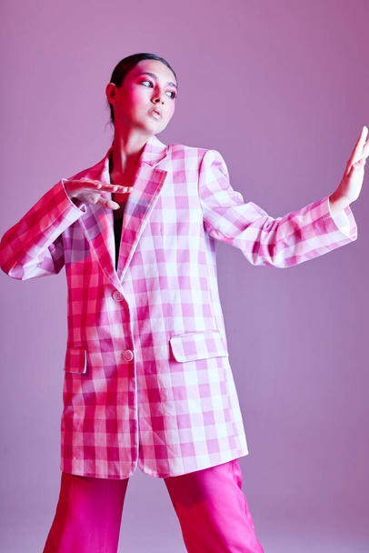 Portrait of beautiful young woman luxury clothing fashion plaid blazer pink background unaltered - Photo, image