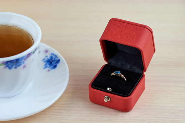 Engagement ring with blue topaz in red box - Foto, immagini