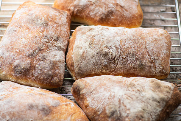 Batch of ciabatta bread on a cooling rack. Close up. - Foto, Imagem
