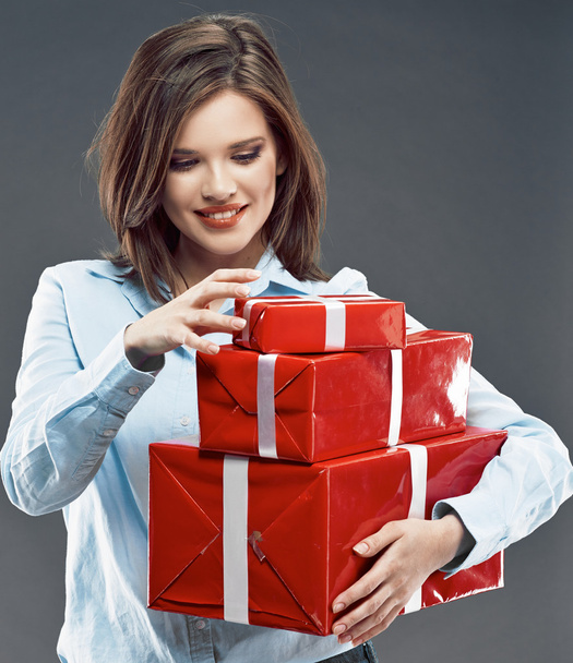 Woman holding red gift boxes. - Foto, Bild