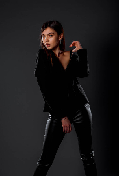 Studio body shot of an attractive woman posing in stylish clothes - 写真・画像