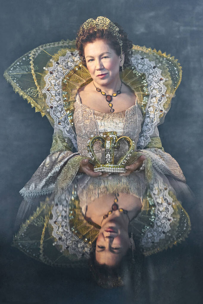 The image of Queen Elizabeth I of the 16th century on a gray background. Historical reconstruction. Playing card concept, reflection - Фото, изображение