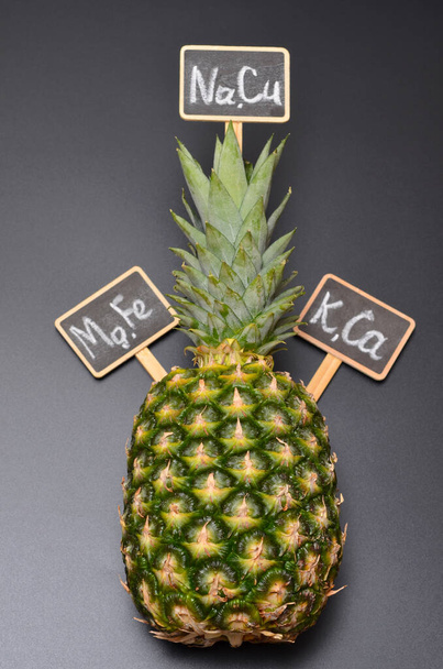 İçinde mikroelementlerin isimlerinin yazılı olduğu ananas ve harfler. - Fotoğraf, Görsel