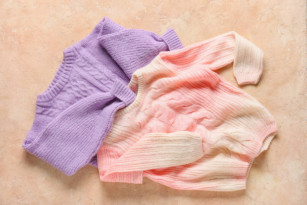 Different children's sweaters on color background - Zdjęcie, obraz