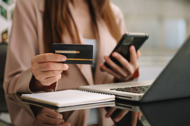 Business woman hands using smartphone and holding credit card sitting. Online Shopping payments  concept. - Φωτογραφία, εικόνα