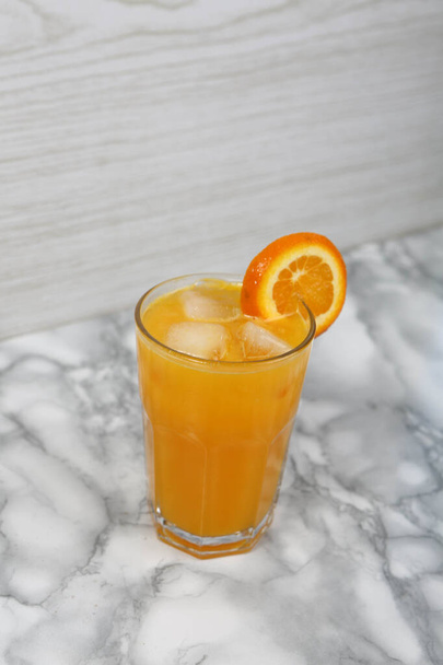A glass of tasty orange juice - Fotó, kép