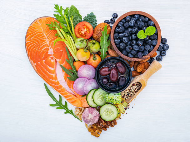 Heart shape of ketogenic low carbs diet concept. Ingredients for healthy foods selection on white wooden background. - Foto, Imagem