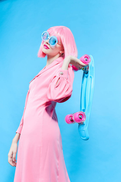 pretty woman in sunglasses wears a pink wig studio model unaltered - Photo, Image