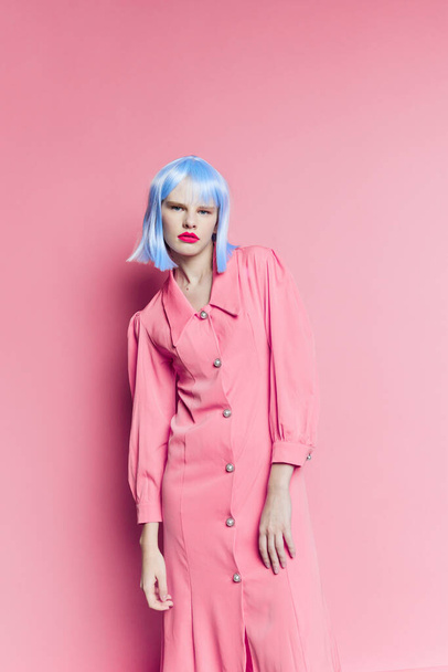 female in blue wig pink dress red lips isolated background - 写真・画像