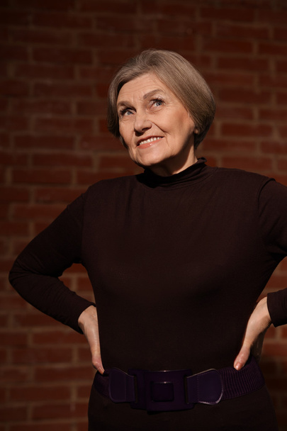 Elderly woman on black background - Фото, зображення