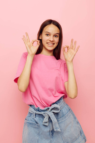 beautiful woman in stylish clothes posing emotions pink background - 写真・画像