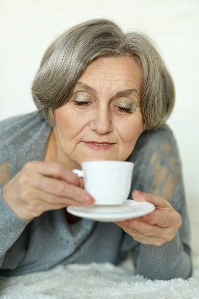 Elderly woman drinking coffee - Fotoğraf, Görsel