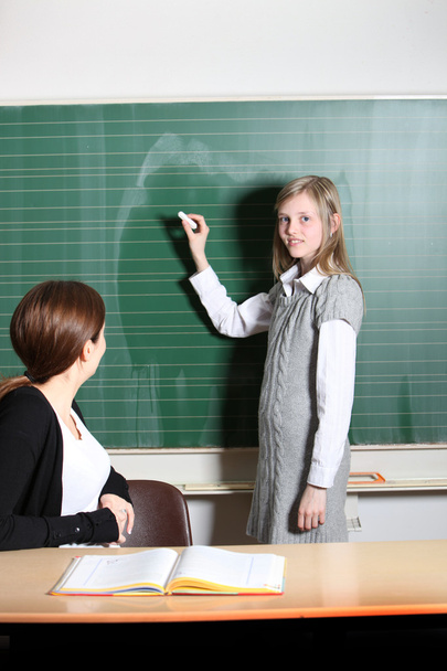 Student in the classroom, writes on the blackboard. - Photo, Image