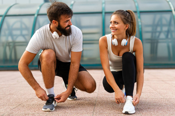 Fitness sport health people and lifestyle concept. Happy fit smiling couple running outdoors - Φωτογραφία, εικόνα