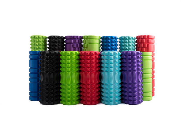 Varied multicolored rollers for massage muscle relaxation after training. Sports equipment for self-massage isolated on white background. Front view. - Foto, imagen