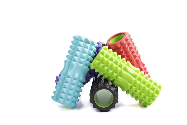 Stack of multicolored myofascial foam roller for self-massage and massaging muscle isolated on white background - Fotoğraf, Görsel