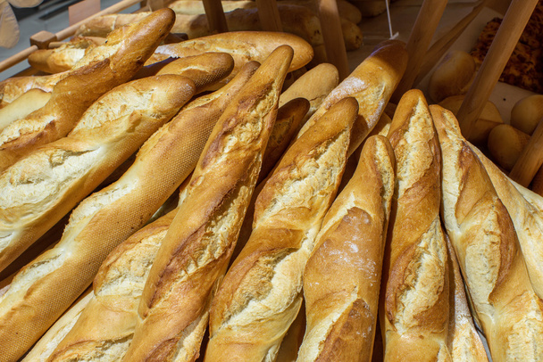 baguette loaf with bran in the store - Fotó, kép