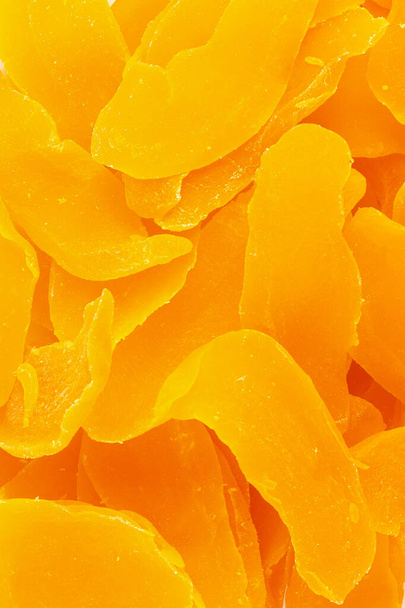 Dried yellow mangoes for proper nutrition scattering closeup top view background - Φωτογραφία, εικόνα
