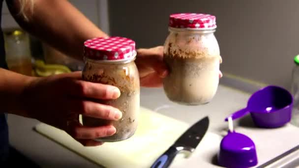 two jars close up with chia pudding breakfast ,meal prep - Materiał filmowy, wideo