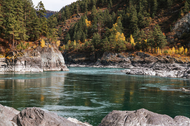 Mountain river surrounded by high rocks in Altai in autumn - Photo, image
