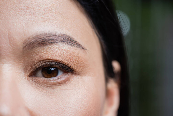 partial view of asian woman looking at camera, eye care concept - Fotografie, Obrázek