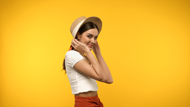 Pretty woman in straw hat looking at camera isolated on yellow  - Fotografie, Obrázek