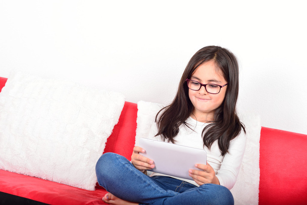 Schoolgirl learning with a Tablet PC at home - Photo, Image